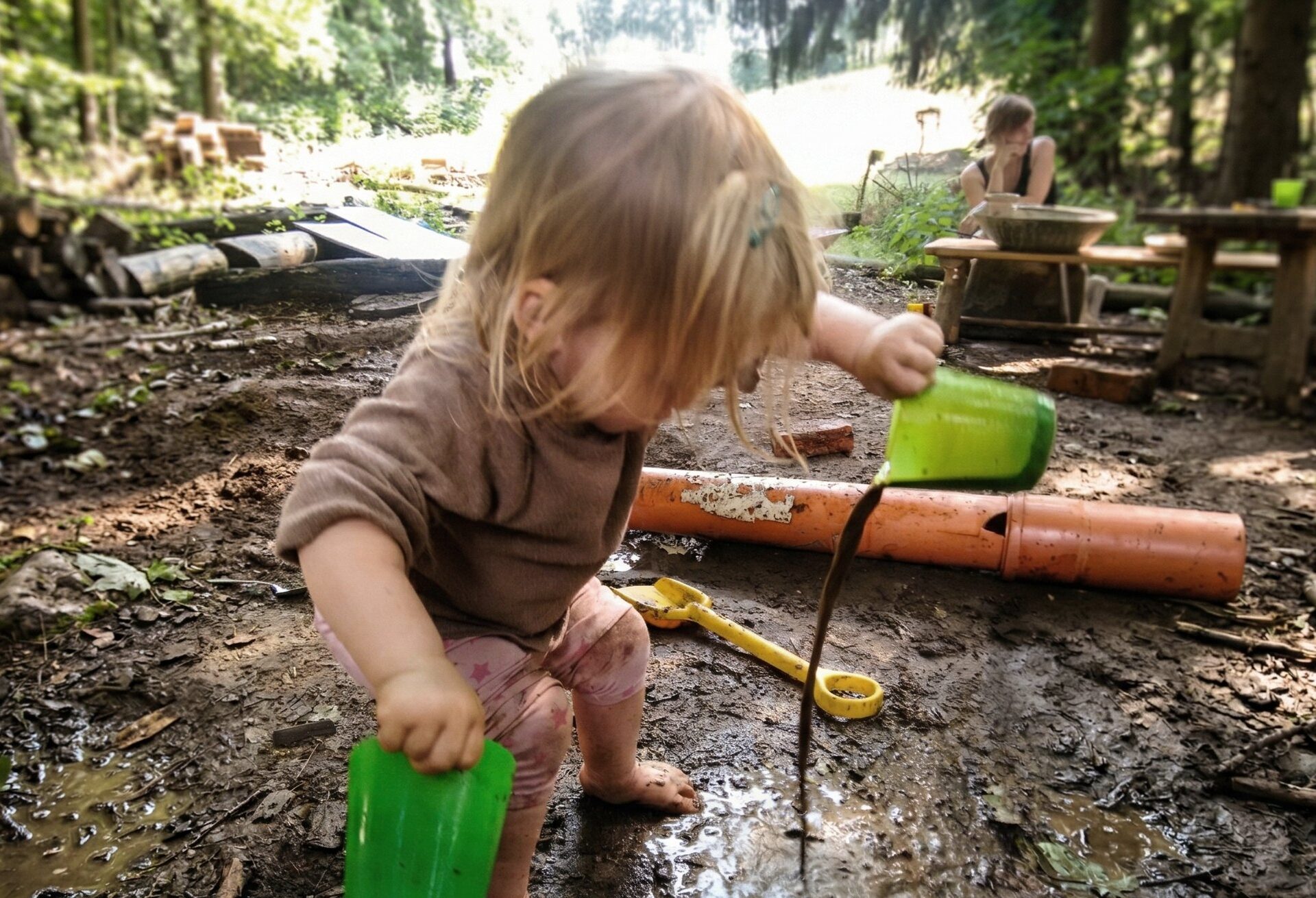 Kleinkind im Wald mit Begleitperson